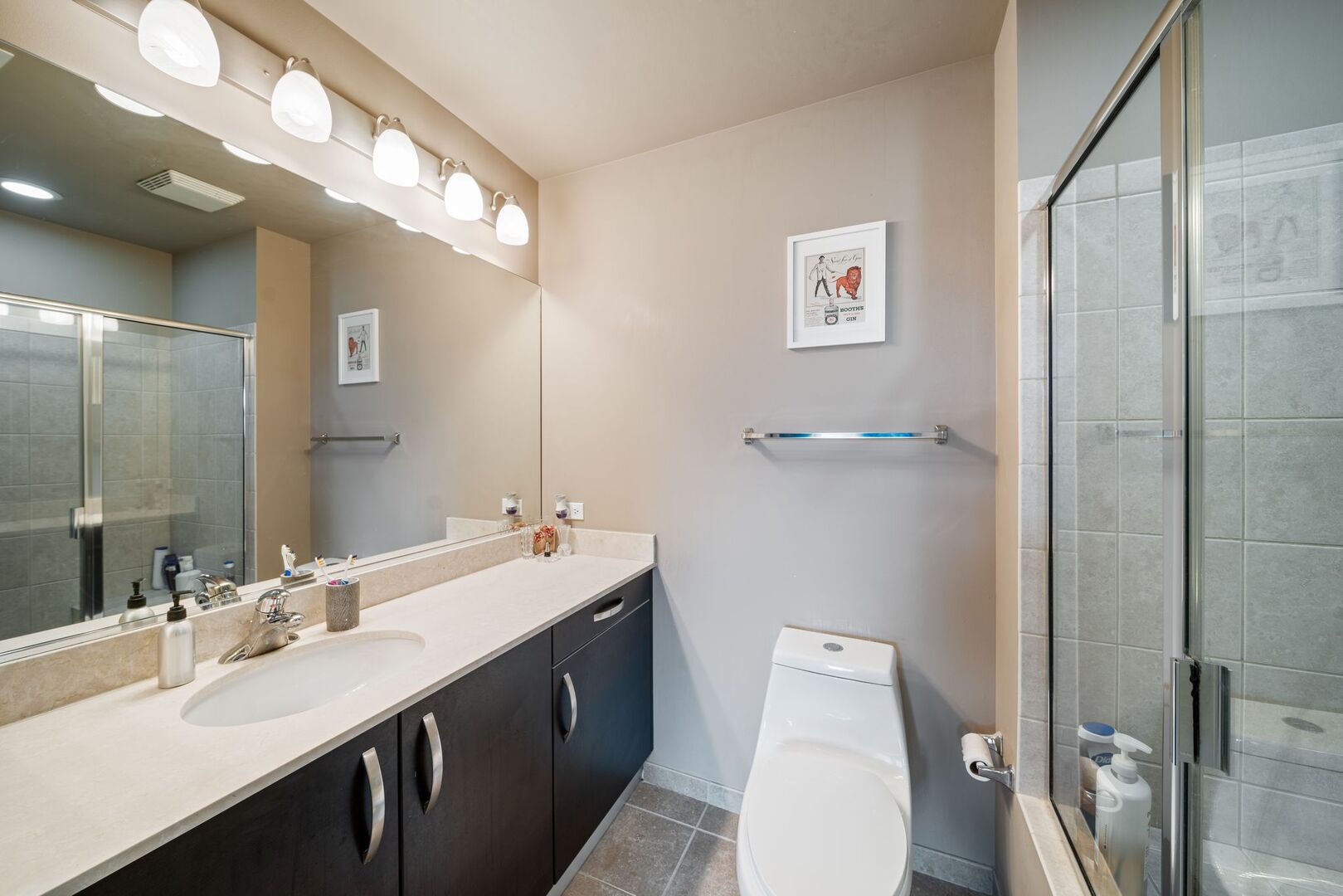 225 South Sangamon Street, Unit 308 Chicago, IL 60607 - Photo 16 of 34 a bathroom with a double vanity sink toilet and a mirror