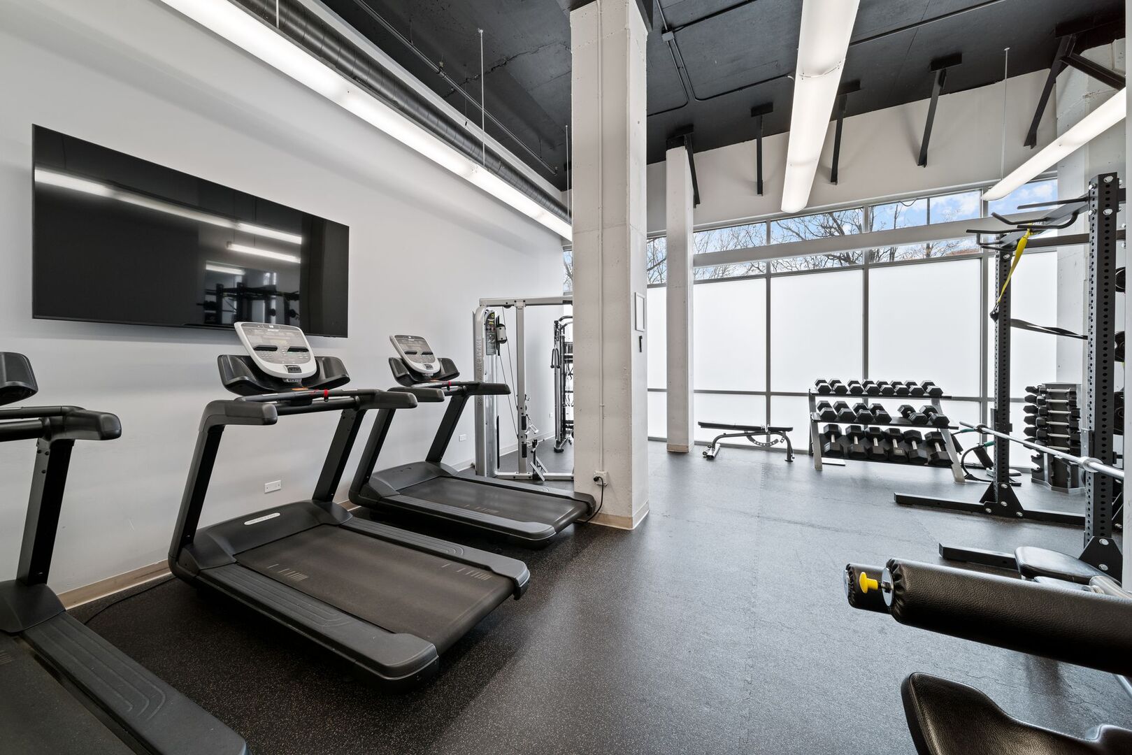 225 South Sangamon Street, Unit 308 Chicago, IL 60607 - Photo 27 of 34 a room with gym equipment and a large window