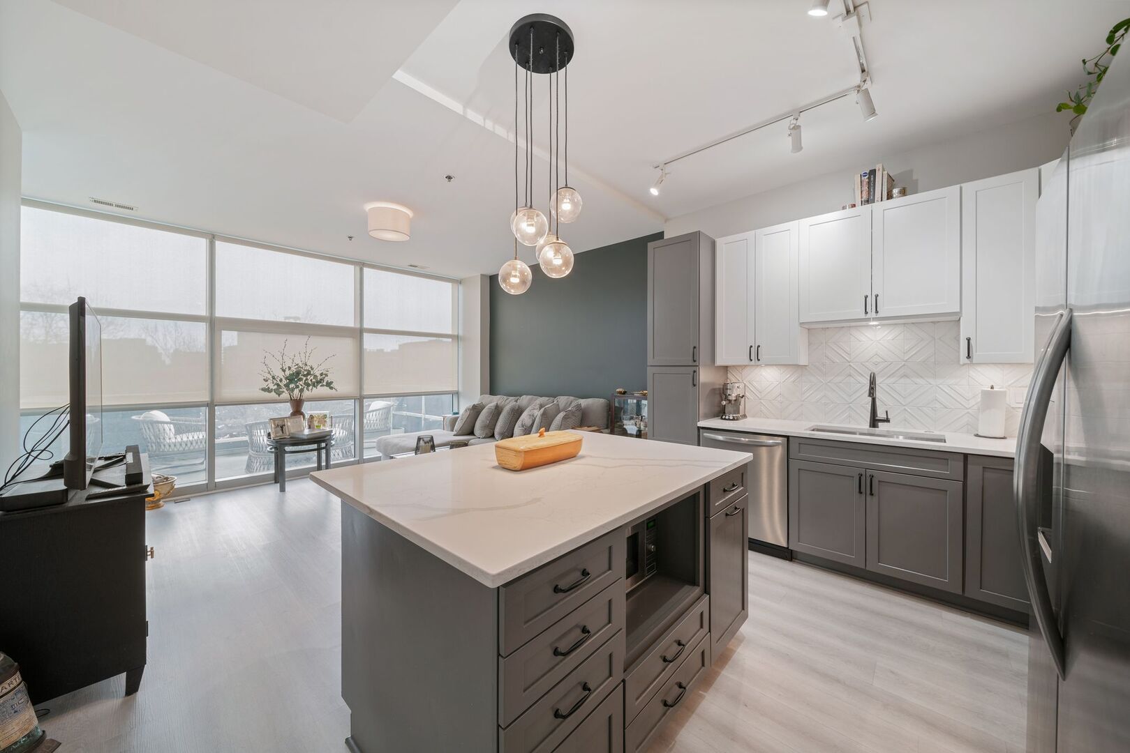 225 South Sangamon Street, Unit 308 Chicago, IL 60607 - Photo 9 of 34 a kitchen that has a lot of cabinets in it and wooden floors