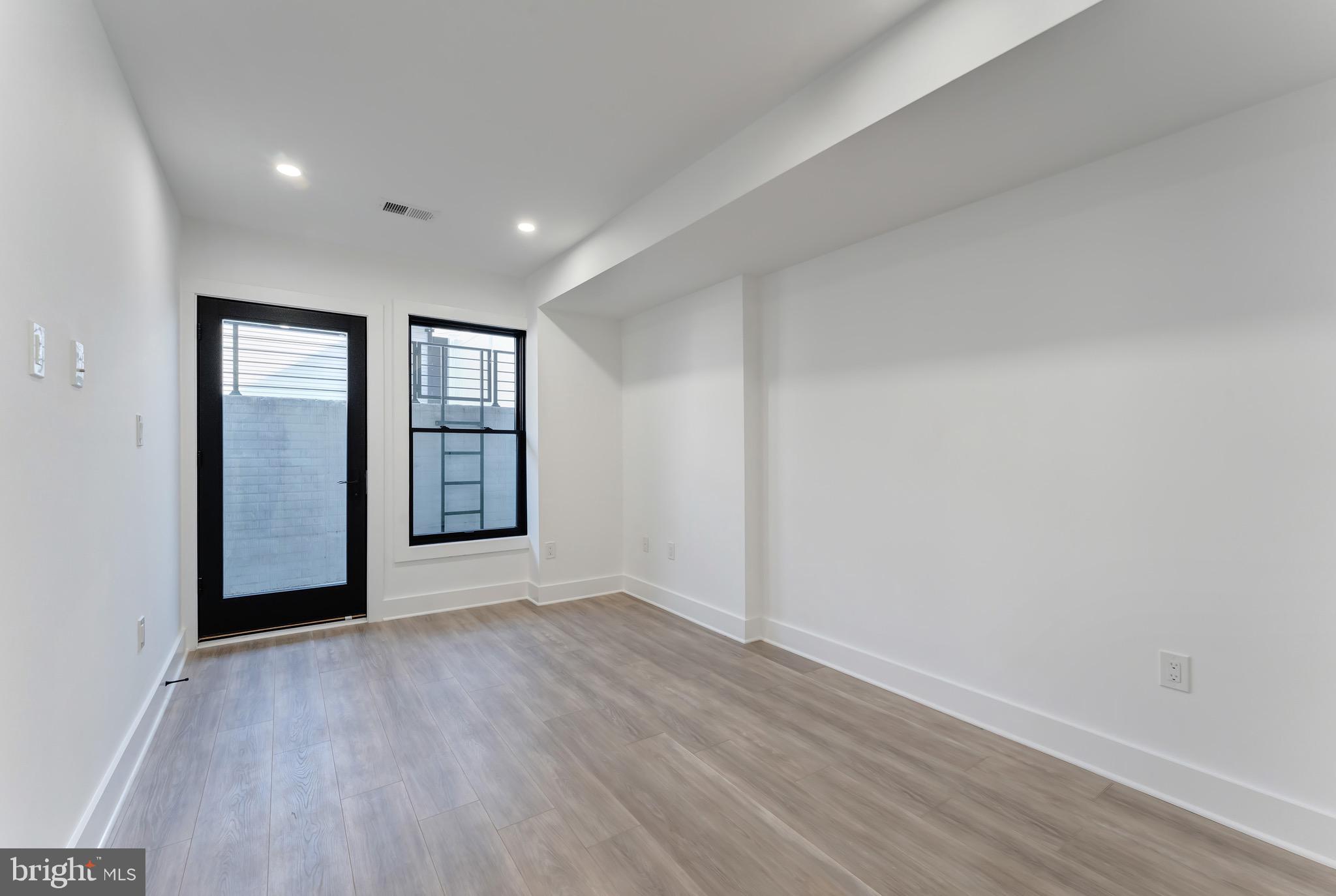 3009 13th Street Northwest, Unit 1 Washington, DC 20009 - Photo 28 of 42 wooden floor in an empty room with a window
