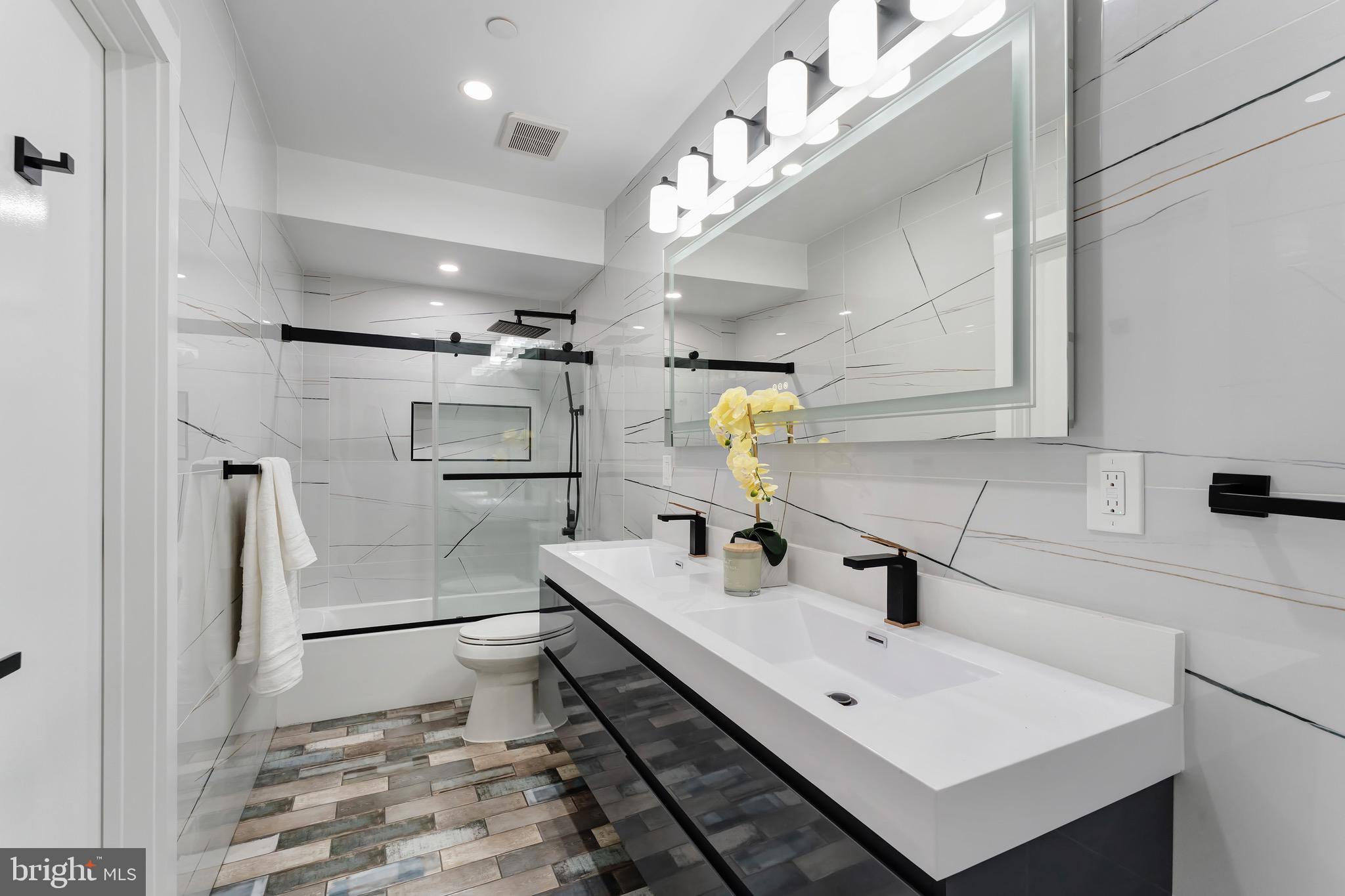 3009 13th Street Northwest, Unit 1 Washington, DC 20009 - Photo 30 of 42 a bathroom with a sink and mirror