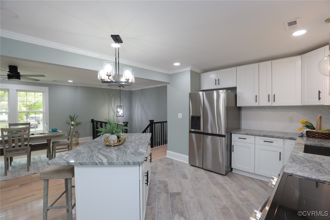 901 Rosegill Road Chesterfield, VA 23236 - Photo 11 of 30 a kitchen with kitchen island granite countertop stainless steel appliances a stove refrigerator and cabinets