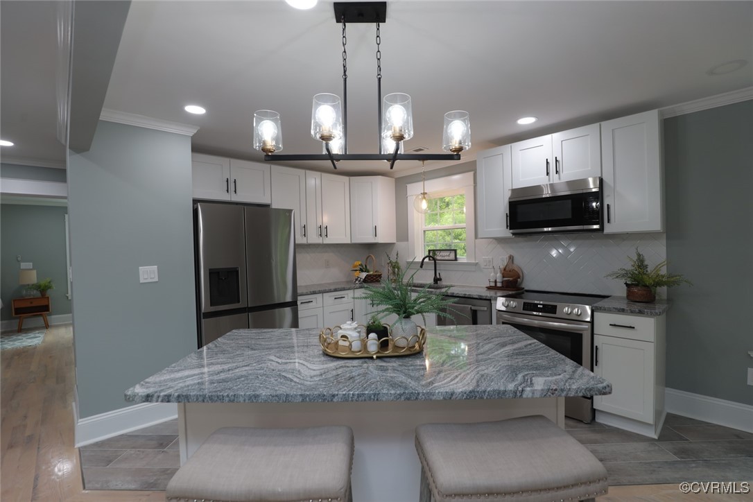 901 Rosegill Road Chesterfield, VA 23236 - Photo 13 of 30 a kitchen with stainless steel appliances granite countertop a sink a stove a refrigerator a microwave a dining table and chairs