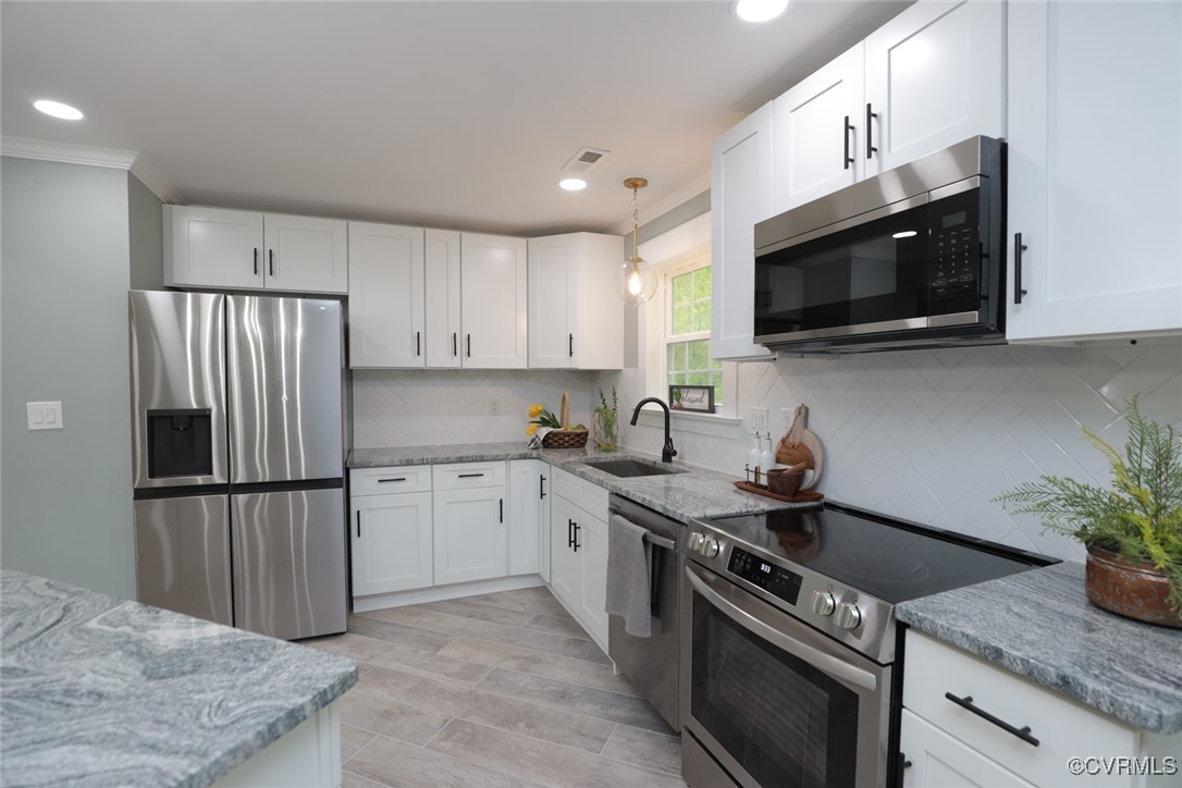 901 Rosegill Road Chesterfield, VA 23236 - Photo 14 of 30 a kitchen with stainless steel appliances granite countertop a sink stove and microwave