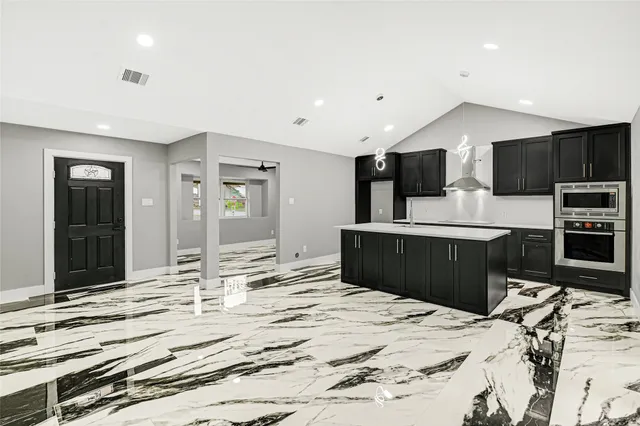 a kitchen with kitchen island granite countertop a sink and counter space