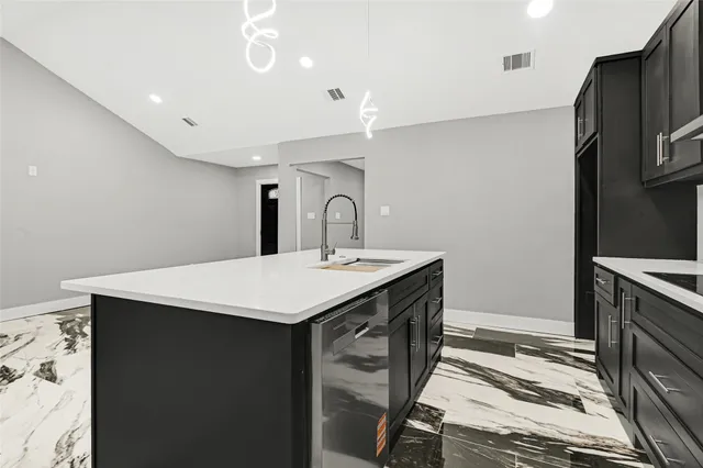 a kitchen with a sink stainless steel appliances and cabinets