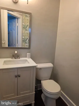 a bathroom with a sink toilet and mirror