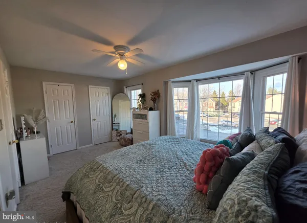 a spacious bedroom with a bed and a chandelier
