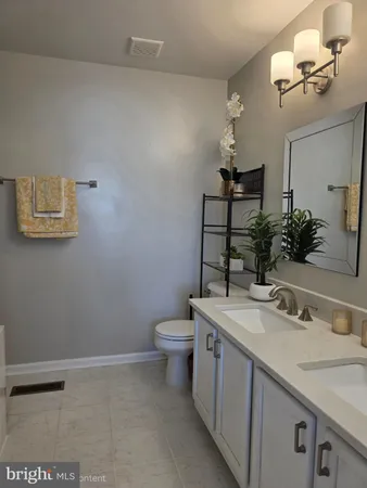 a bathroom with a sink a toilet and mirror