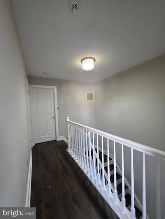 a hallway with wooden floor in a room