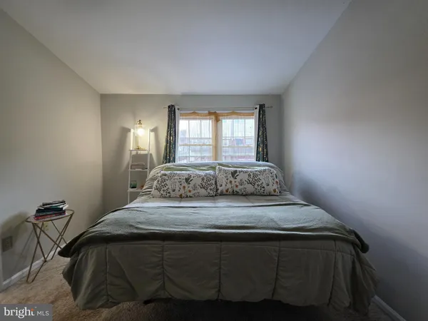 a bedroom with a bed and window