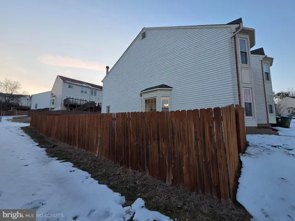 a view of a house with wooden fence