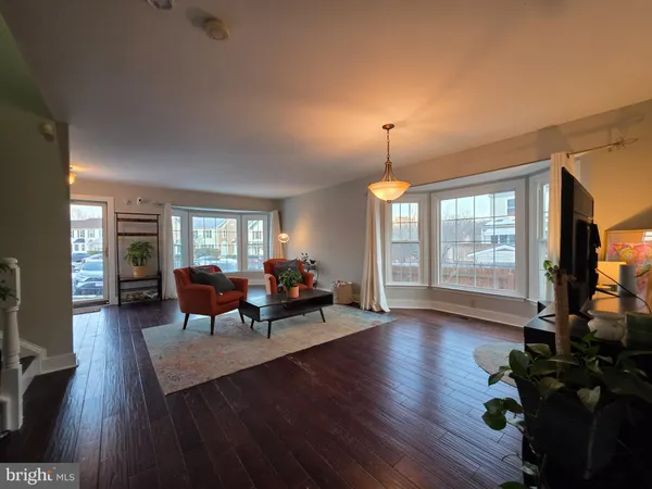 a living room with fireplace furniture and a wooden floor