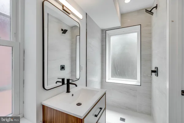 a bathroom with a sink mirror and vanity