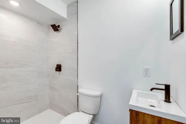 a white toilet sitting next to a bathroom sink