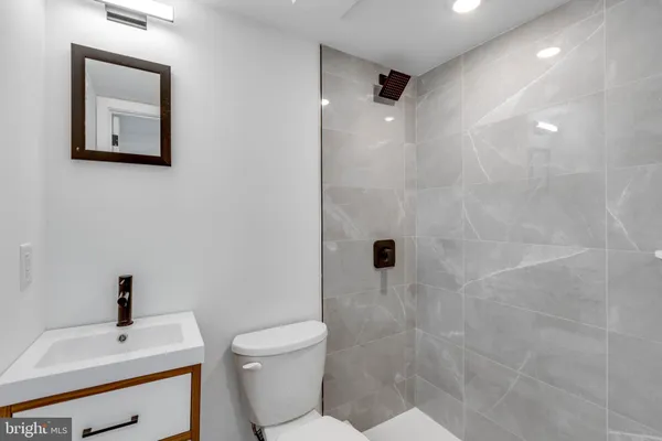 a bathroom with a toilet sink and shower