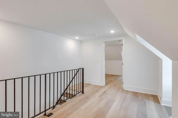 a view of hallway with wooden floor