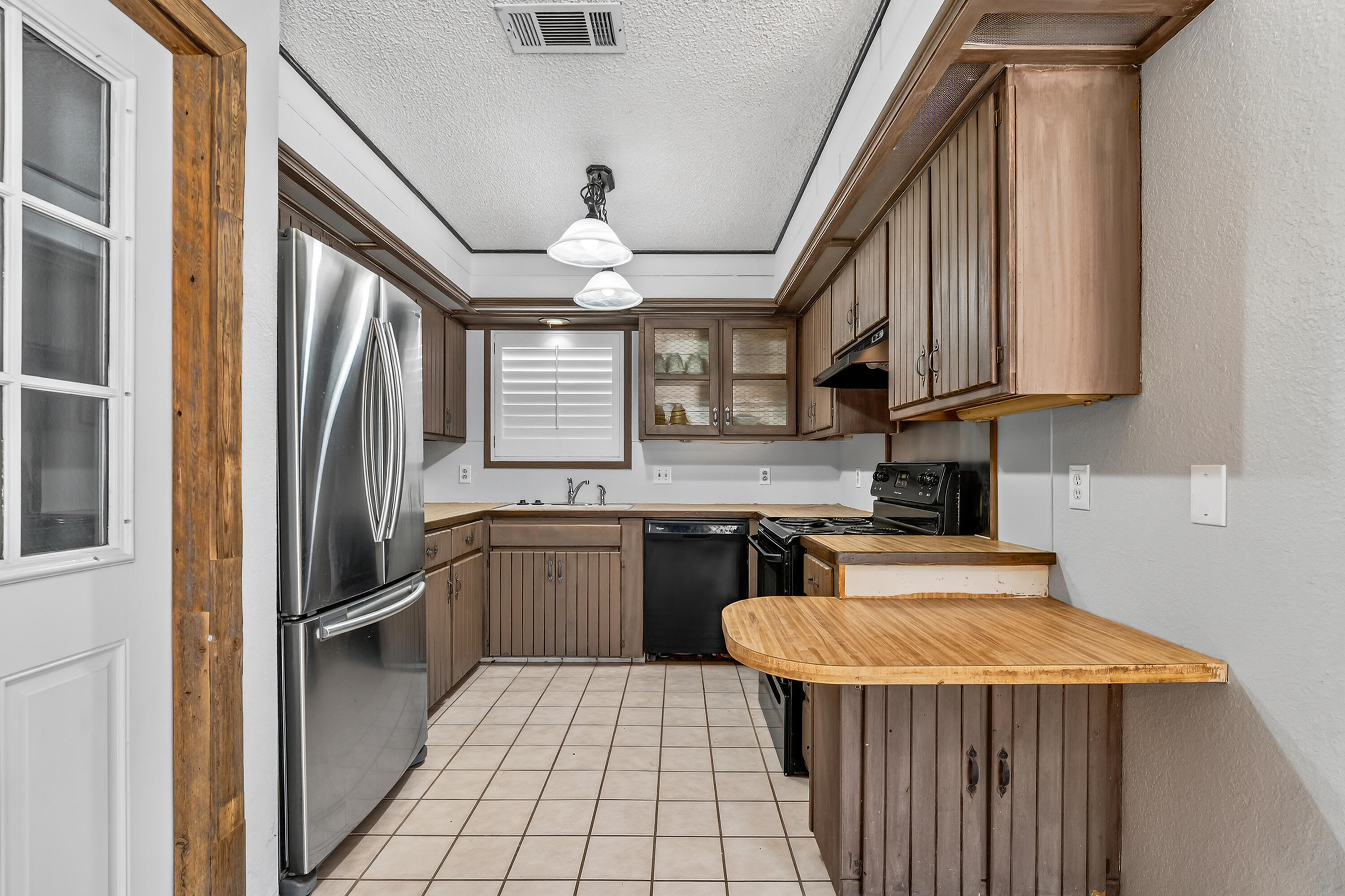 5236 91st Street Lubbock, TX 79424 - Photo 9 of 23 a kitchen with stainless steel appliances granite countertop a sink stove and refrigerator