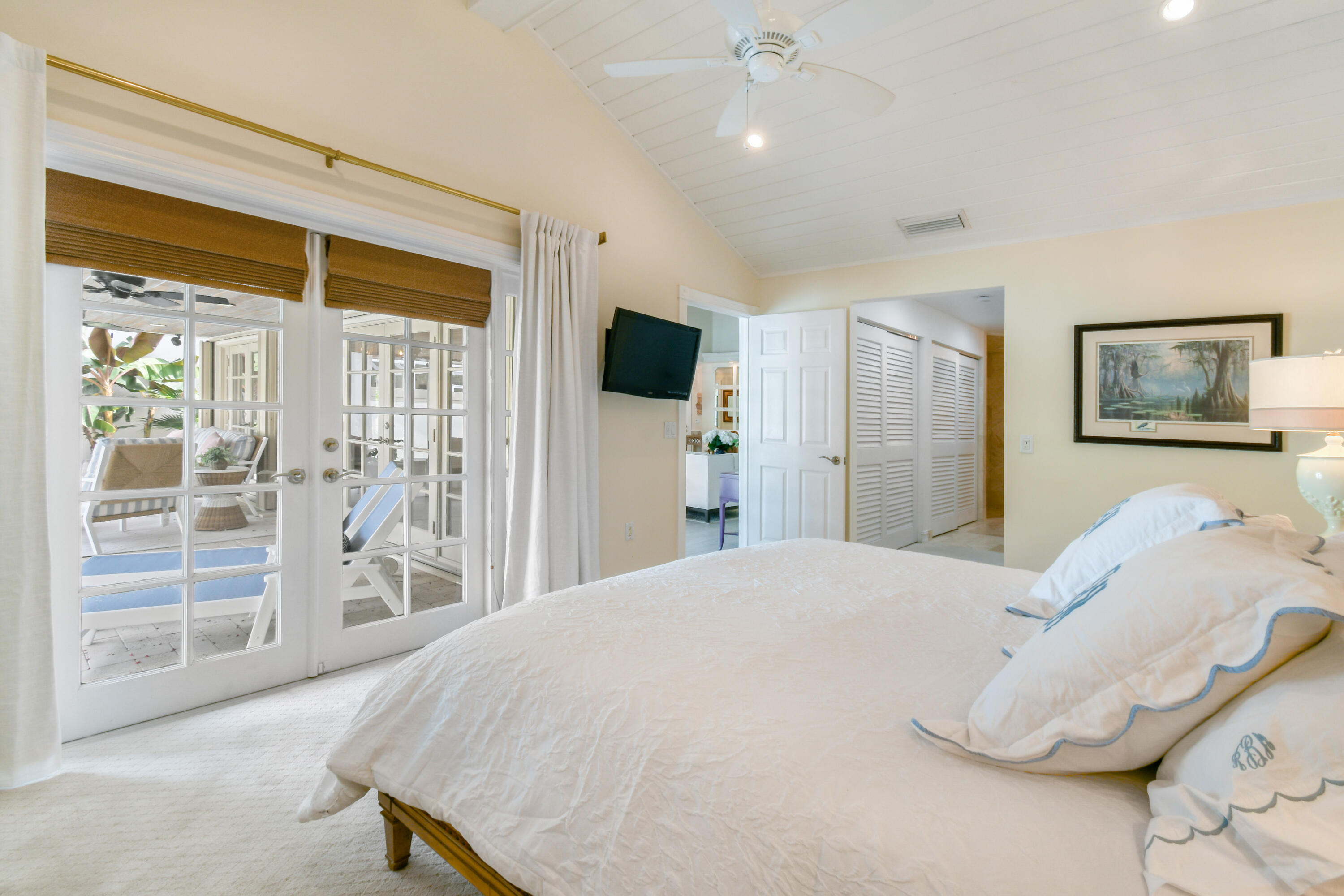 127 Dunes Edge Road Jupiter, FL 33477 - Photo 32 of 58 a spacious bedroom with a bed and a large window