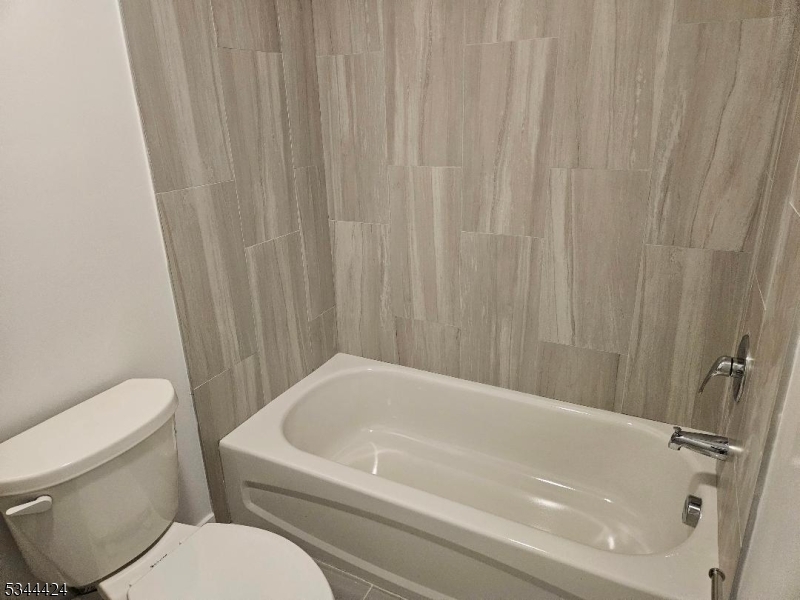 685 Bergen Street Newark, NJ 07108 - Photo 12 of 12 a bathroom with a white bath tub and toilet