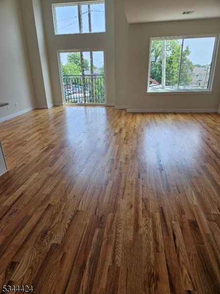 685 Bergen Street Newark, NJ 07108 - Photo 3 of 12 wooden floor in an empty room with a window