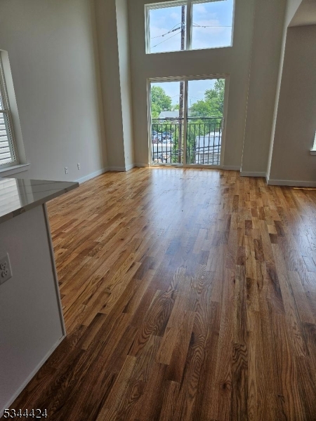 685 Bergen Street Newark, NJ 07108 - Photo 5 of 12 a view of an empty room with wooden floor and a window
