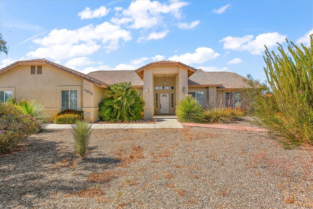 13838 Cree Road Apple Valley, CA 92307 - Photo 1 of 1 a front view of a house with garden