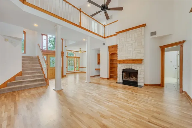 a view of a livingroom with wooden floor and a fireplace