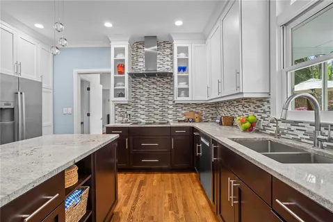 a kitchen with stainless steel appliances granite countertop a sink stove and refrigerator