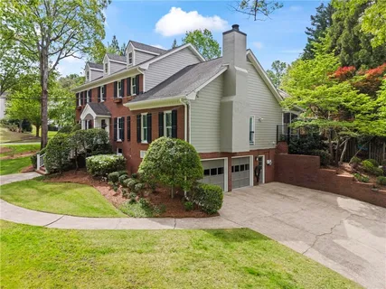 a view of a house with backyard and sitting area