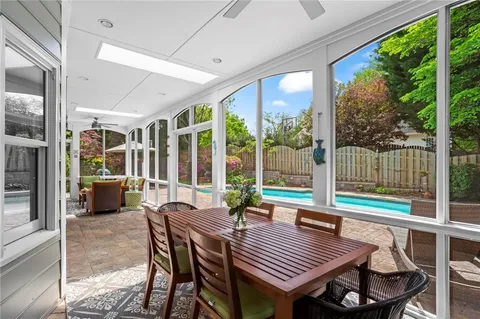 a view of a house with swimming pool and sitting area
