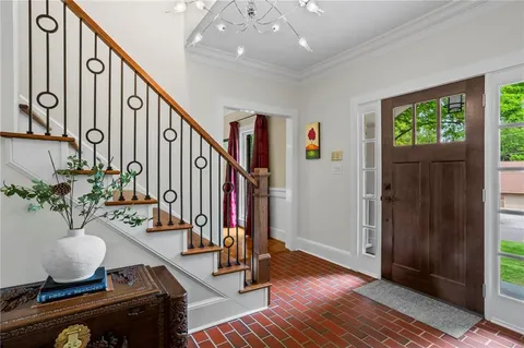 a living room with stairs and furniture