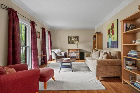 a living room with furniture and a book shelf