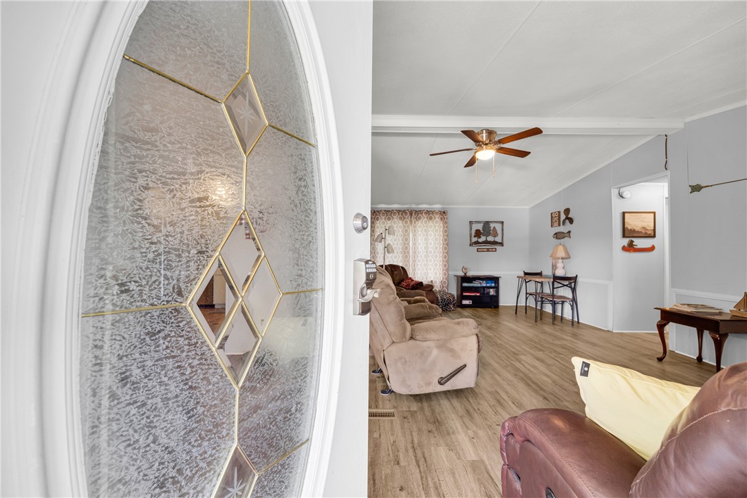 334 Lake Becky Road Mountain Rest, SC 29664 - Photo 6 of 46 Enter into a warm living space featuring durable flooring and a ceiling fan for comfort.