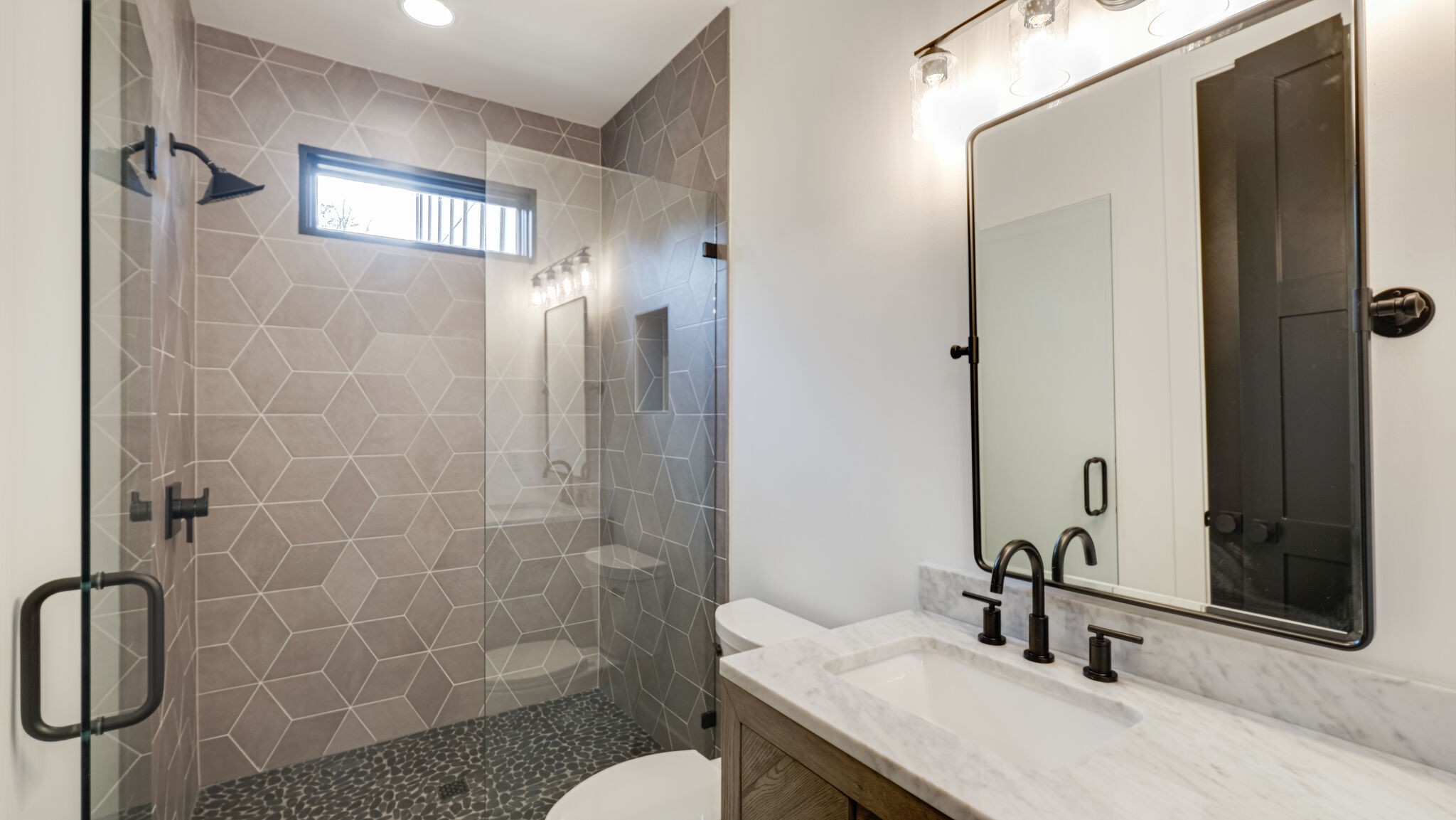 8564 Taliaferro Road Eagleville, TN 37060 - Photo 22 of 49 a bathroom with a granite countertop sink a toilet and shower