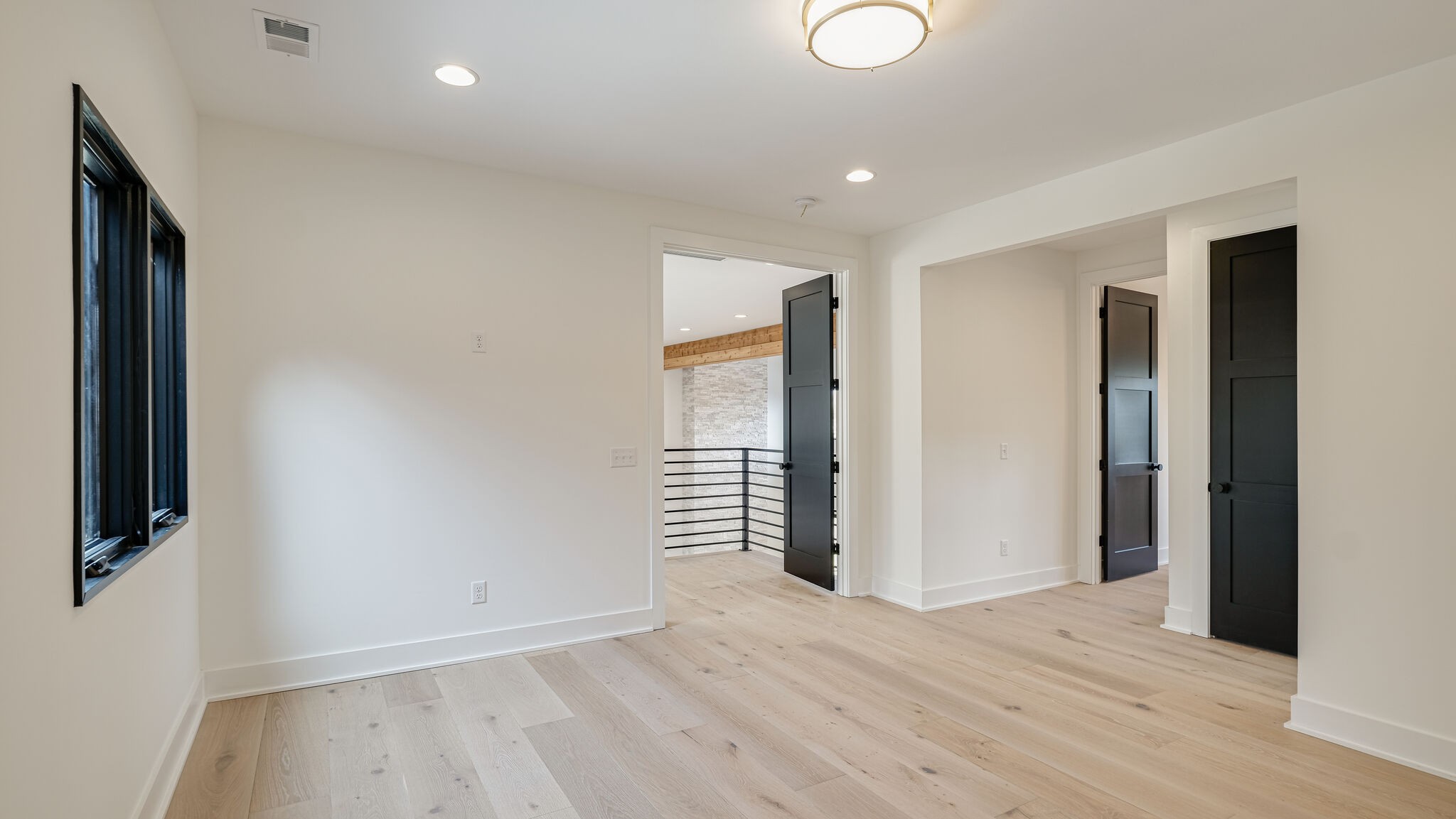 8564 Taliaferro Road Eagleville, TN 37060 - Photo 28 of 49 an empty room with wooden floor and windows