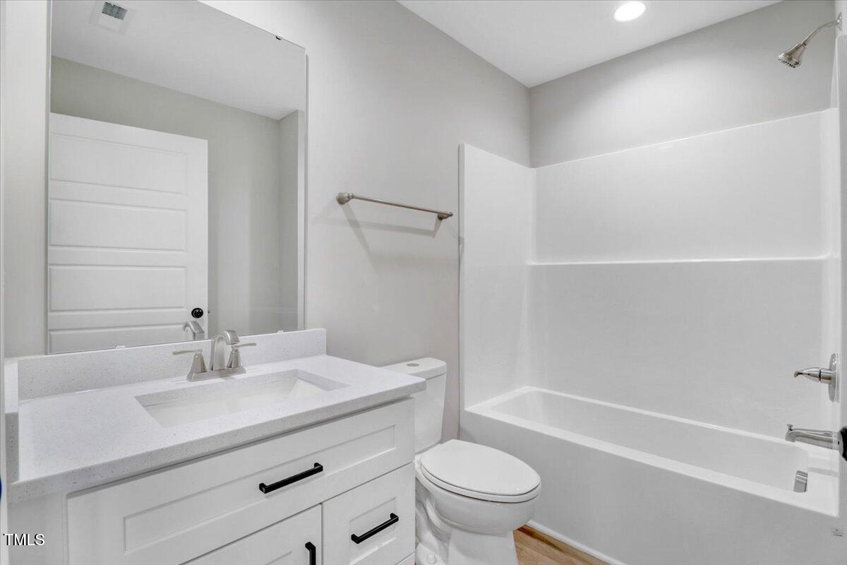 145 East Jay Street Coats, NC 27521 - Photo 12 of 15 a bathroom with a sink a toilet and shower