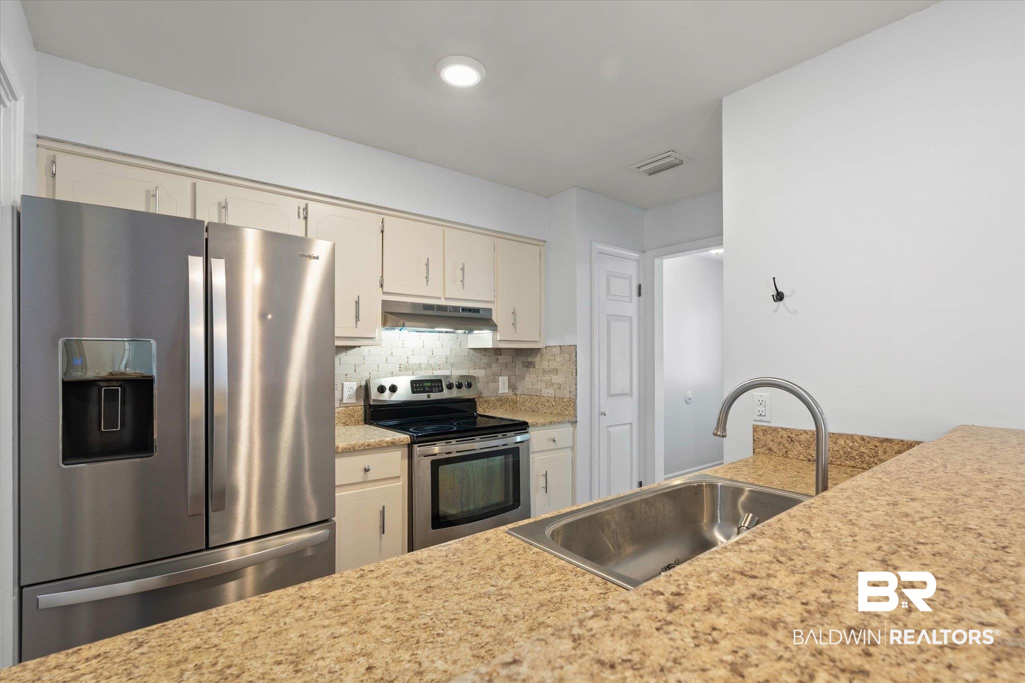 123 Richmond Road Daphne, AL 36526 - Photo 7 of 35 Kitchen featuring stainless steel appliances, under cabinet range hood, light countertops, and decorative backsplash