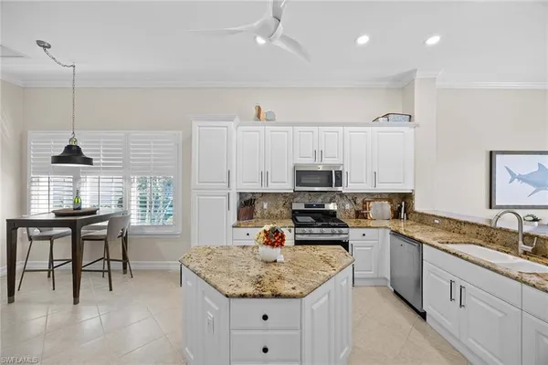 a kitchen with stainless steel appliances granite countertop a sink stove and cabinets