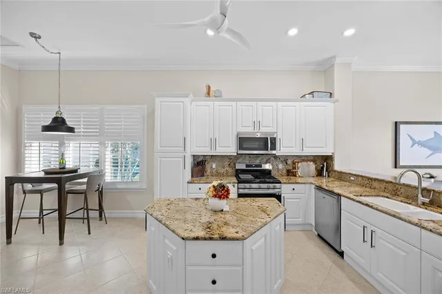 a kitchen with stainless steel appliances granite countertop a sink stove and cabinets