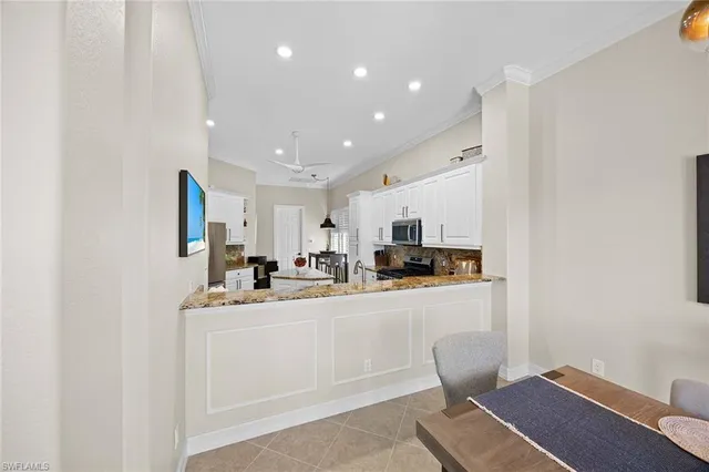 a kitchen with stainless steel appliances a refrigerator and a stove top oven