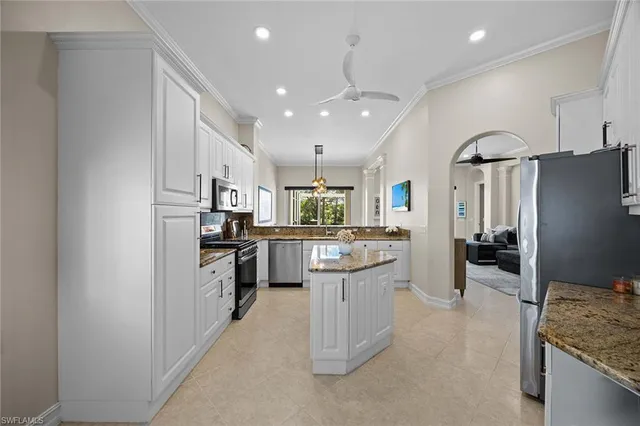 a kitchen with kitchen island a sink stainless steel appliances and cabinets