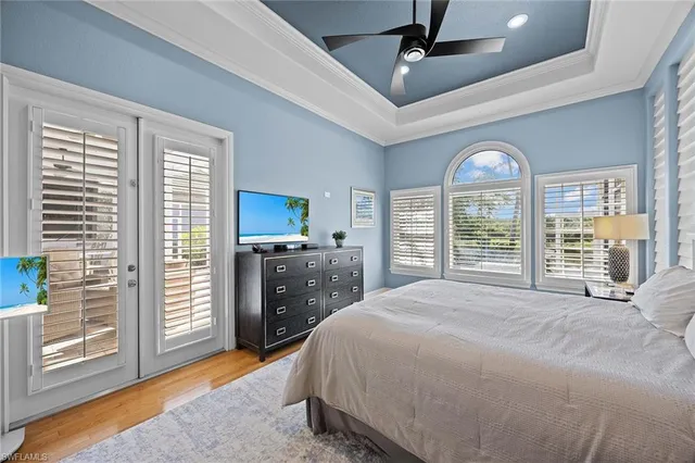 a spacious bedroom with a large bed and a tv