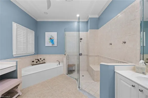 a bathroom with a tub a sink and a large window