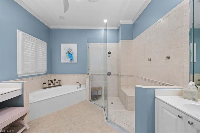 a bathroom with a tub a sink and a large window