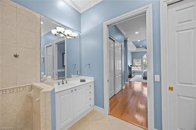 a en suite bathroom with a sink mirror and shower