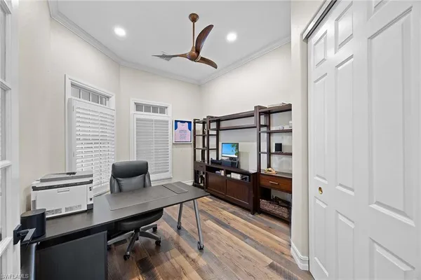 a reading room with wooden floor and furniture