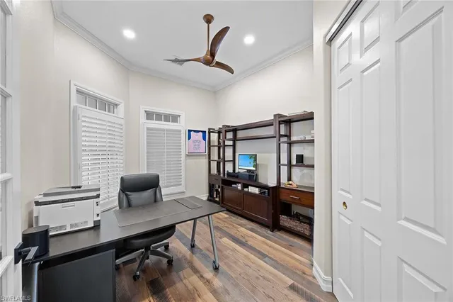 a reading room with wooden floor and furniture