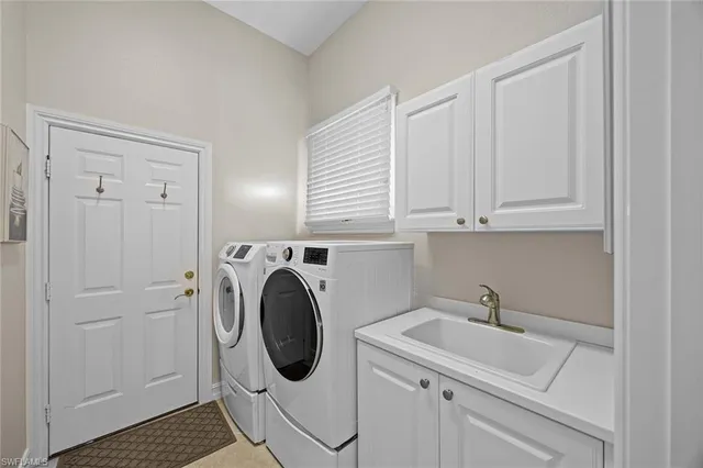 a utility room with sink dryer and washer
