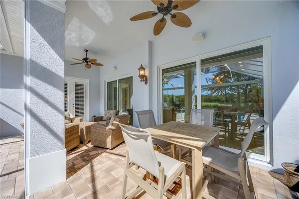 a view of a dining room with furniture a chandelier and wooden floor